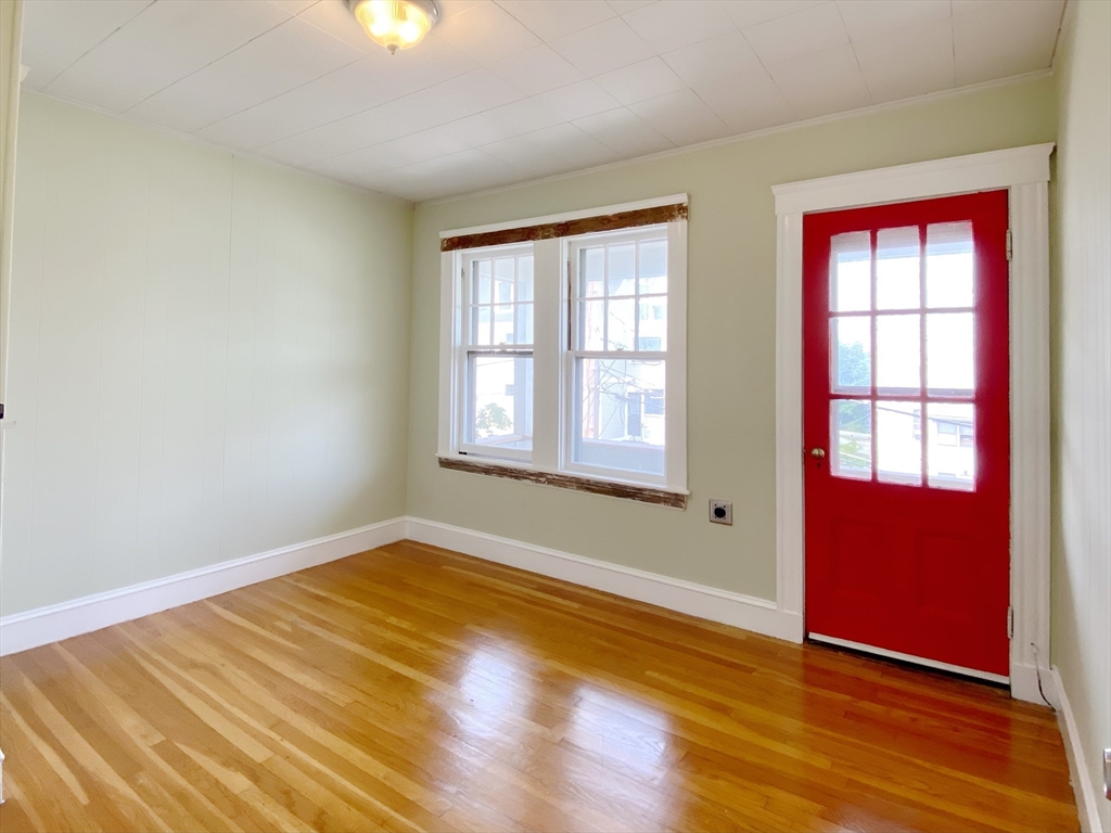 9 Cresthill Road, Unit 2 Somerville, MA 02145 - Photo 17 of 18 an empty room with wooden floor and windows