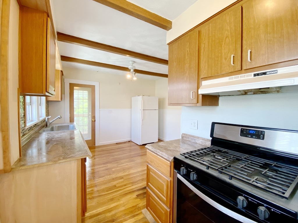 9 Cresthill Road, Unit 2 Somerville, MA 02145 - Photo 3 of 18 a kitchen with a stove and a refrigerator