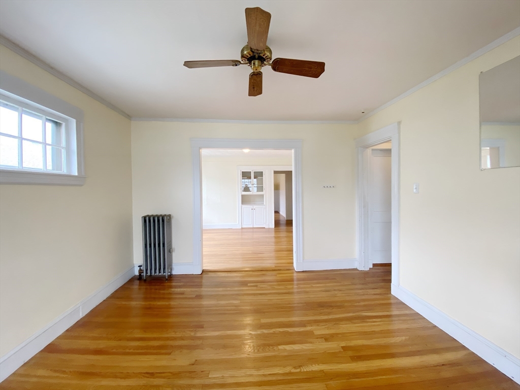 9 Cresthill Road, Unit 2 Somerville, MA 02145 - Photo 5 of 18 a view of empty room with wooden floor