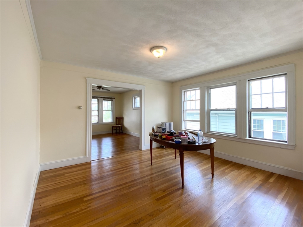 9 Cresthill Road, Unit 2 Somerville, MA 02145 - Photo 8 of 18 a living room with furniture and wooden floor