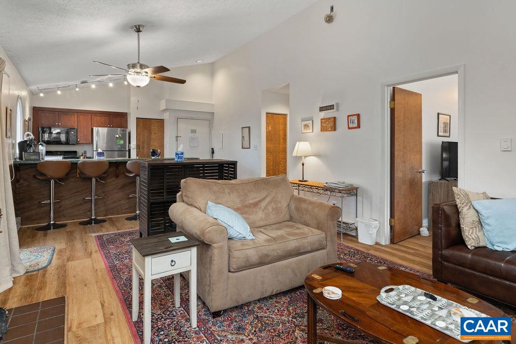 2224 Tanners Ridge, Unit 2224 Wintergreen, VA 22967 - Photo 8 of 18 a living room with furniture a chandelier and a dining table