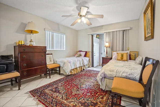 a bedroom with two beds and a chandelier