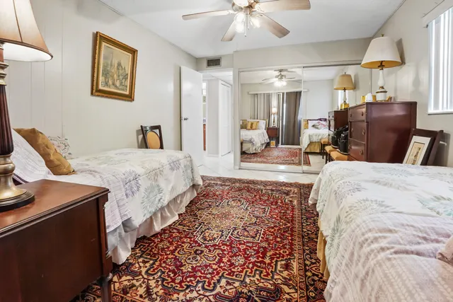 a spacious bedroom with a bed and wooden floor