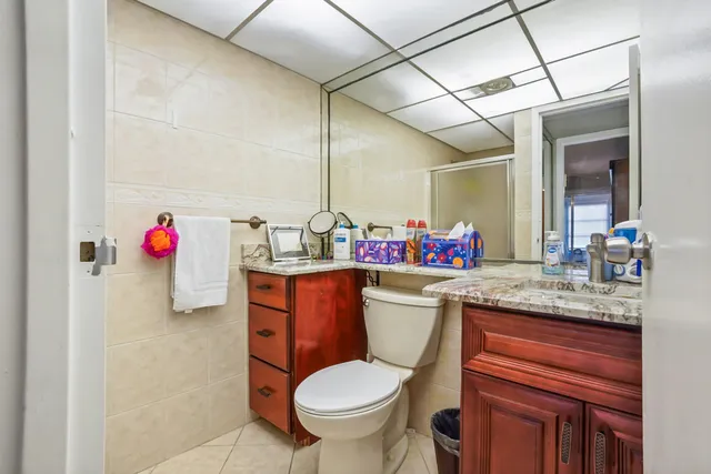 a bathroom with a toilet sink and mirror