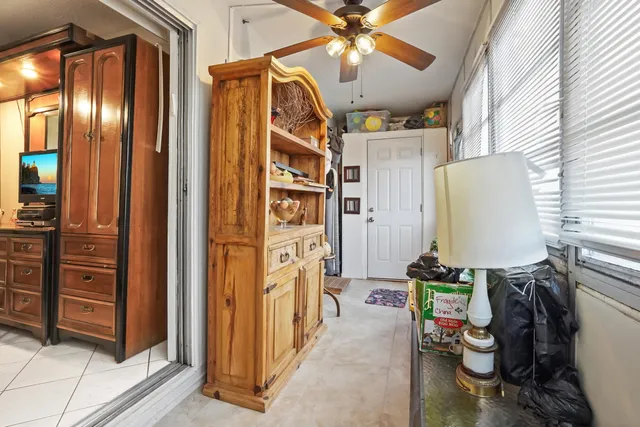 a view of a entryway with furniture and chandelier fan