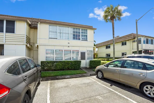 a front view of a house with parking space