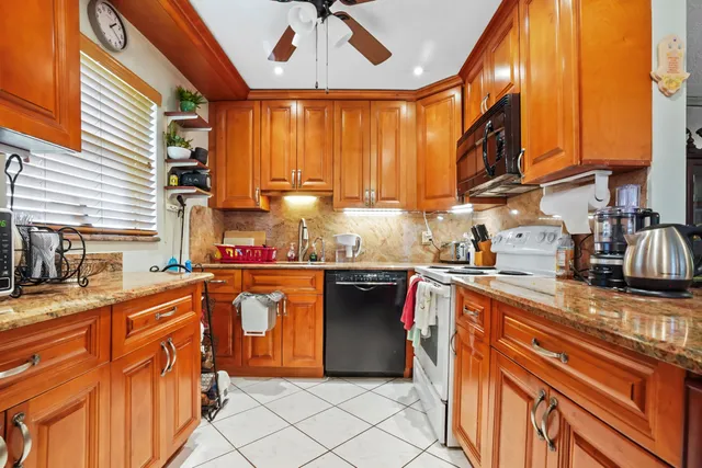 a kitchen with stainless steel appliances granite countertop a sink and cabinets