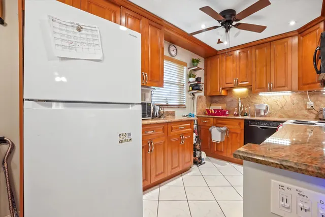 a kitchen with a refrigerator and a sink