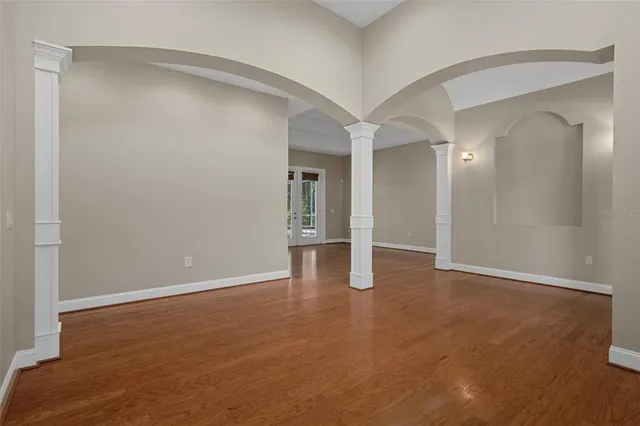 a kitchen with granite countertop cabinets stainless steel appliances and a wooden floor