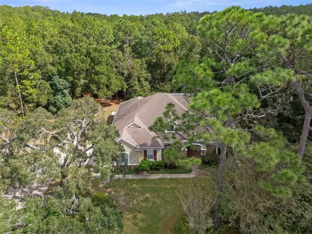 a aerial view of a house with a yard