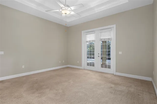an empty room with a chandelier fan