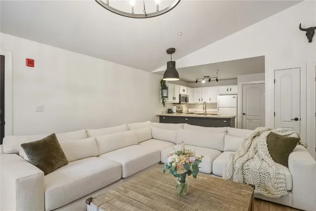 a living room with furniture and kitchen view
