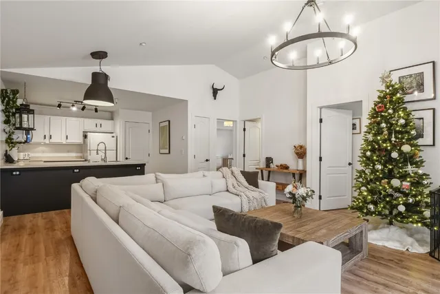 a living room with furniture flowers and a chandelier