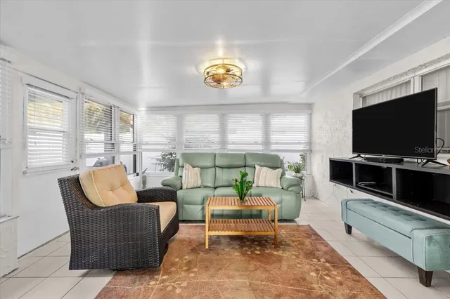a view of a dining room with furniture and a chandelier