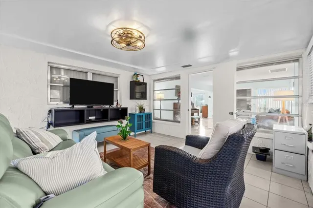 a dining room with furniture and a view of living room