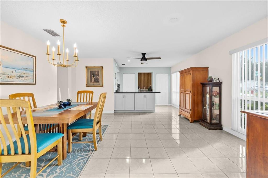 4880 Shell Stream Boulevard New Port Richey, FL 34652 - Photo 15 of 57 a view of a dining room with furniture and a chandelier