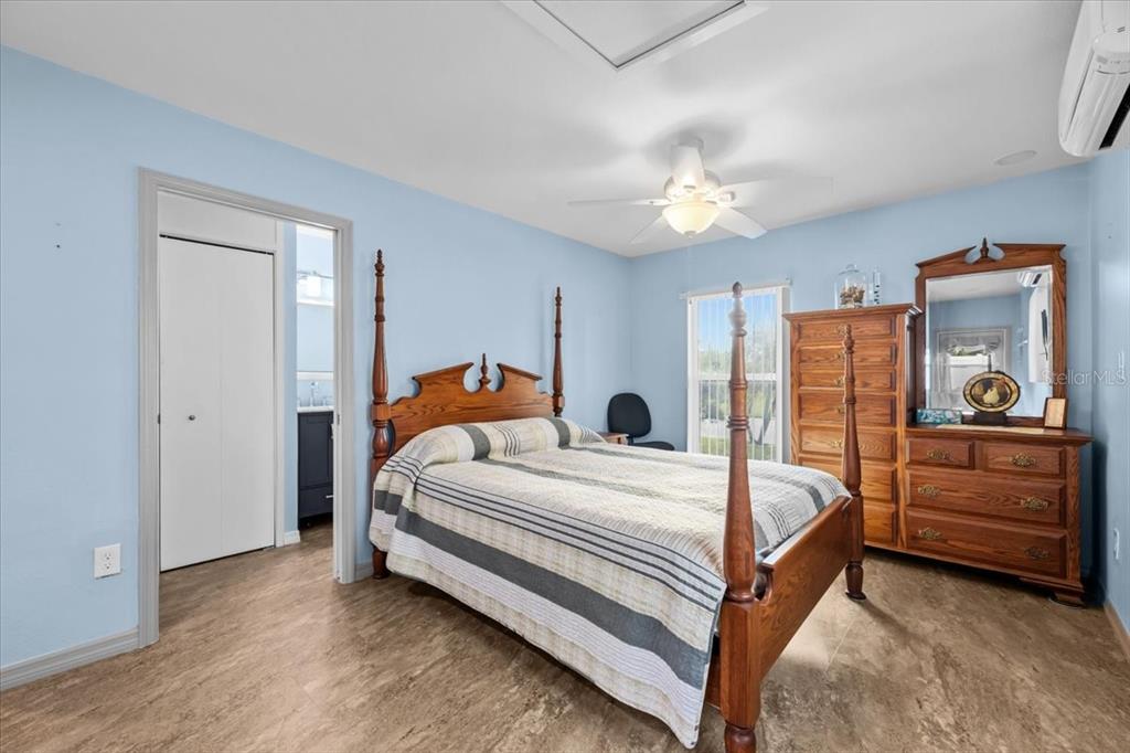 4880 Shell Stream Boulevard New Port Richey, FL 34652 - Photo 16 of 25 a bedroom with a bed and a chandelier