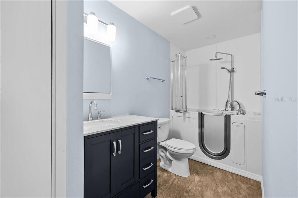 4880 Shell Stream Boulevard New Port Richey, FL 34652 - Photo 17 of 25 a bathroom with a granite countertop toilet sink and mirror