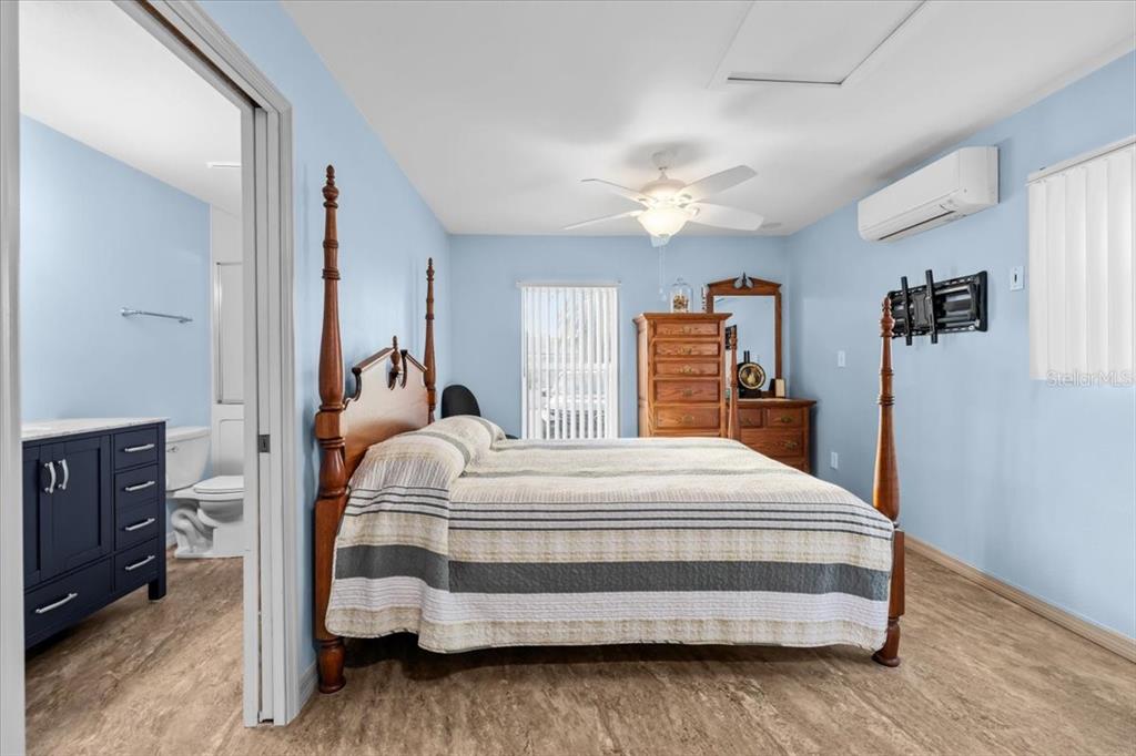 4880 Shell Stream Boulevard New Port Richey, FL 34652 - Photo 28 of 57 a bedroom with bed and a chandelier