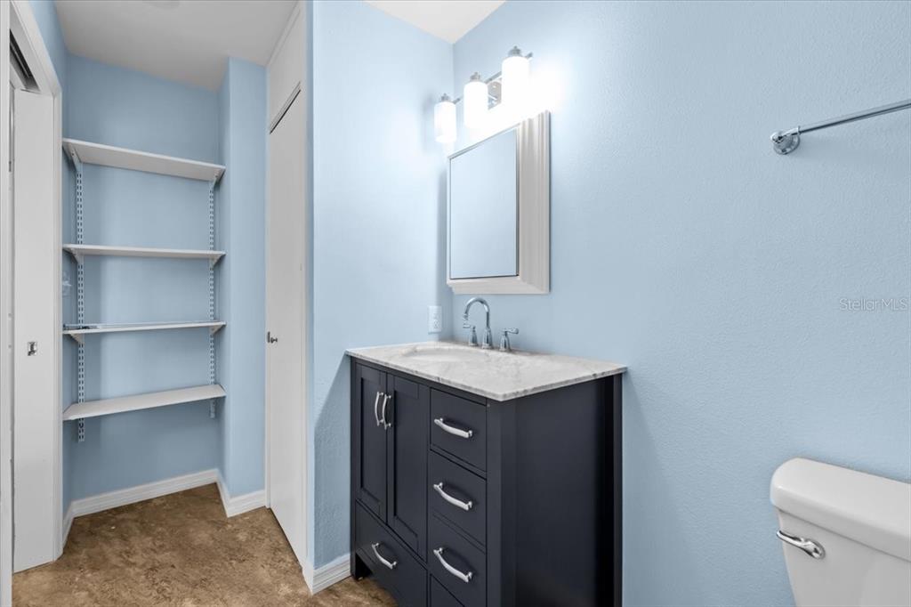 4880 Shell Stream Boulevard New Port Richey, FL 34652 - Photo 33 of 57 a bathroom with a granite countertop sink and a toilet