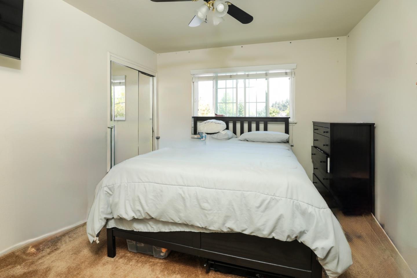 494 Dover Way Campbell, CA 95008 - Photo 15 of 28 a large bed sitting in a bedroom next to a window