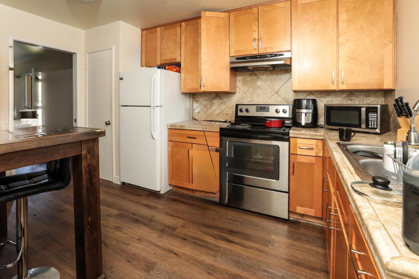 494 Dover Way Campbell, CA 95008 - Photo 26 of 28 a kitchen with stainless steel appliances granite countertop a stove and a refrigerator
