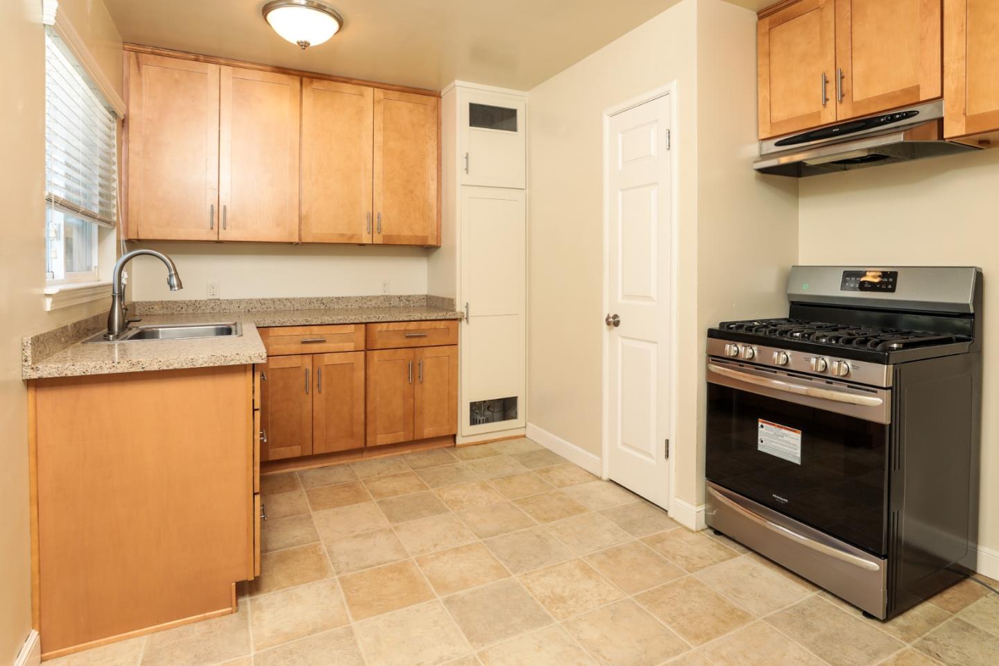 494 Dover Way Campbell, CA 95008 - Photo 5 of 28 a kitchen with stainless steel appliances granite countertop a stove a sink and a microwave