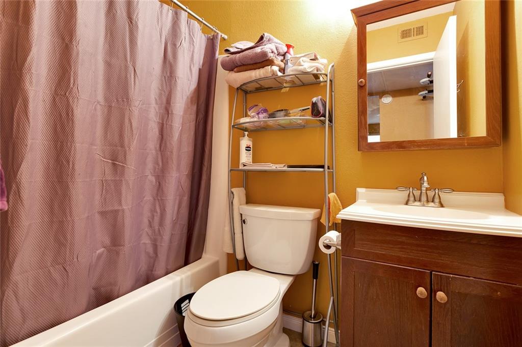 910 Duncan Lane, Unit 35 Austin, TX 78705 - Photo 13 of 20 A well-appointed bath with integrated vanity storage and a shower-tub combination.