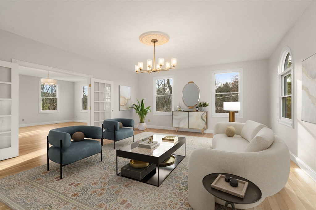 140 York Street Canton, MA 02021 - Photo 11 of 27 a living room with furniture a rug and a chandelier