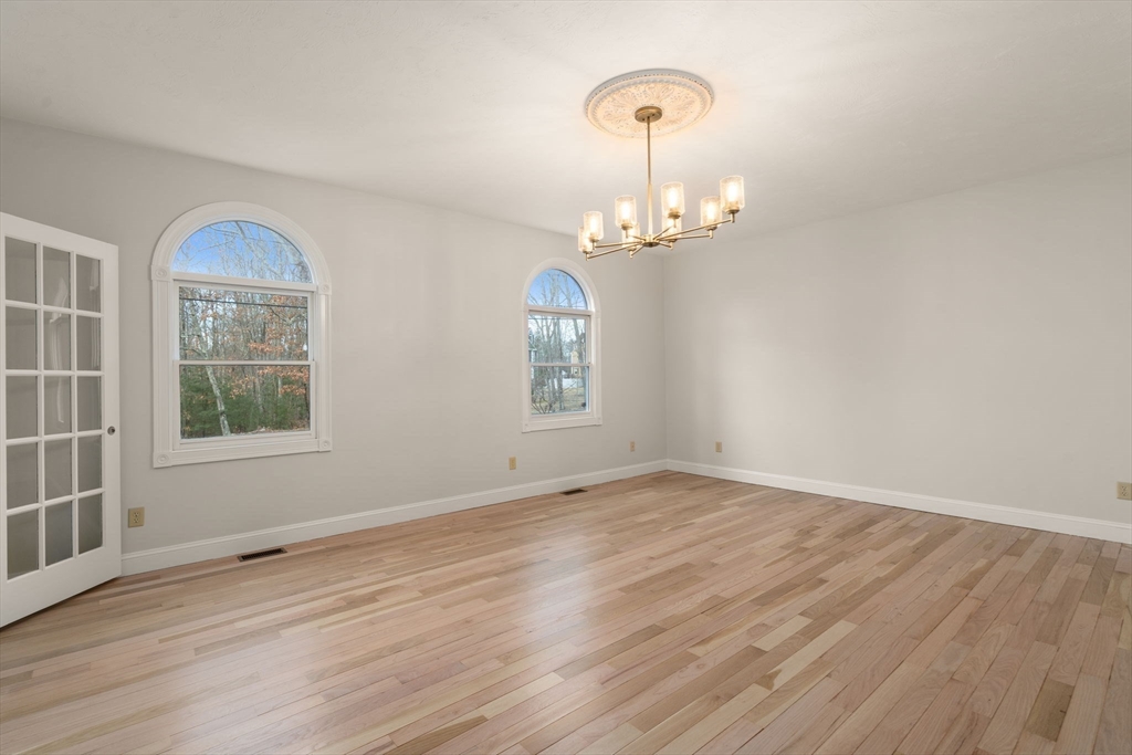 140 York Street Canton, MA 02021 - Photo 12 of 27 an empty room with wooden floor exposed radiator and windows