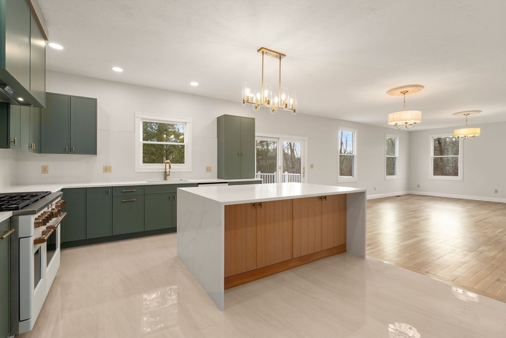 140 York Street Canton, MA 02021 - Photo 5 of 27 a large kitchen with stainless steel appliances a large counter top a stove and a sink