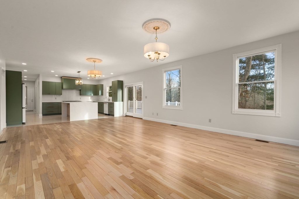 140 York Street Canton, MA 02021 - Photo 8 of 27 a view of a kitchen with a sink hardwood floor and a large window
