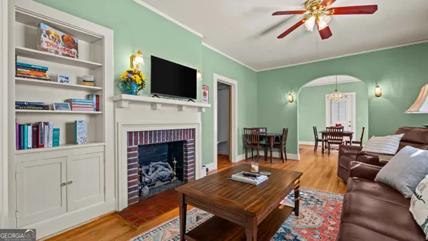 a living room with furniture a flat screen tv and a fireplace