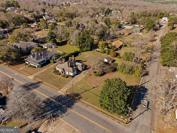 an aerial view of a house with a yard