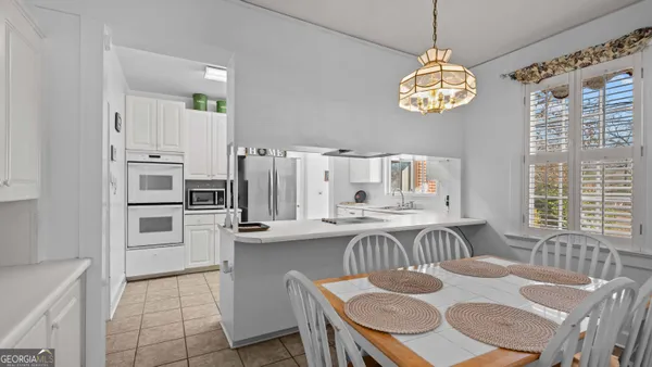 a kitchen with a table chairs and microwave