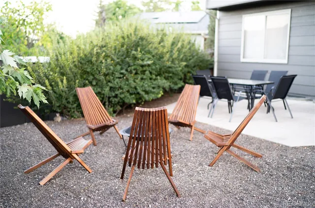 a view of backyard with a table and chairs