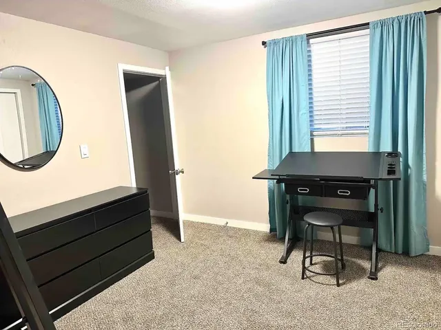 a room that has a dresser and a chair in it