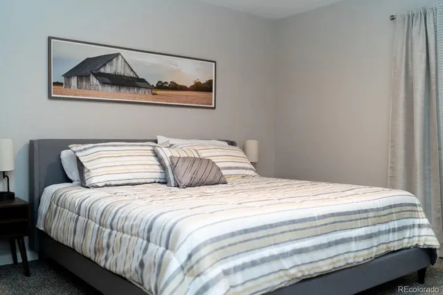 a bedroom with a bed and wall painting