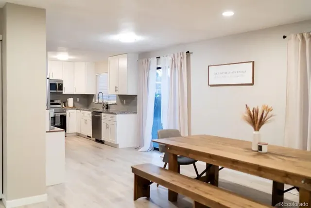 a kitchen with stainless steel appliances a stove a sink and a refrigerator
