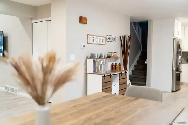 a view of a kitchen with furniture and a refrigerator
