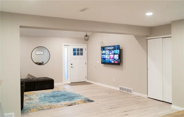 a view of a livingroom with wooden floor and a window