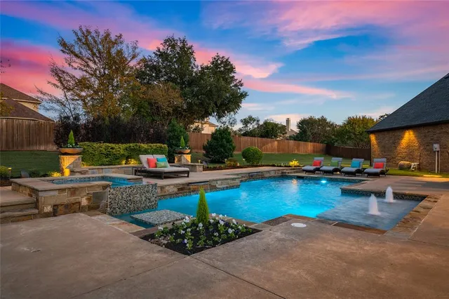 a view of swimming pool with outdoor seating and plants