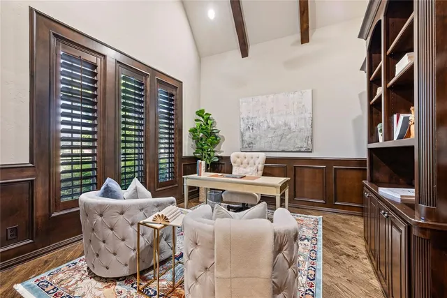 a living room with furniture a flat screen tv and a floor to ceiling window