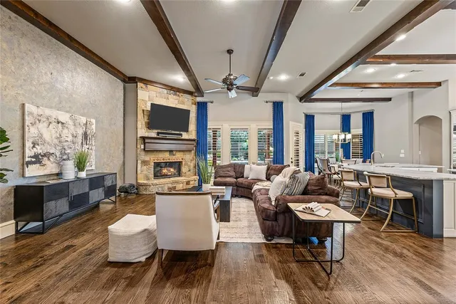 a living room with fireplace furniture and a large window