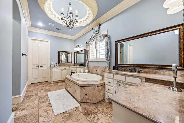 a spacious bathroom with a double vanity sink a mirror and a bathtub
