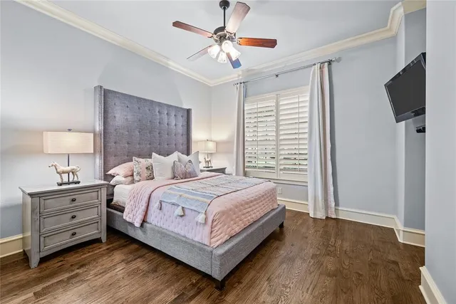 a bedroom with bed tv and a window