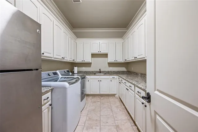 a kitchen with stainless steel appliances granite countertop a stove and a refrigerator