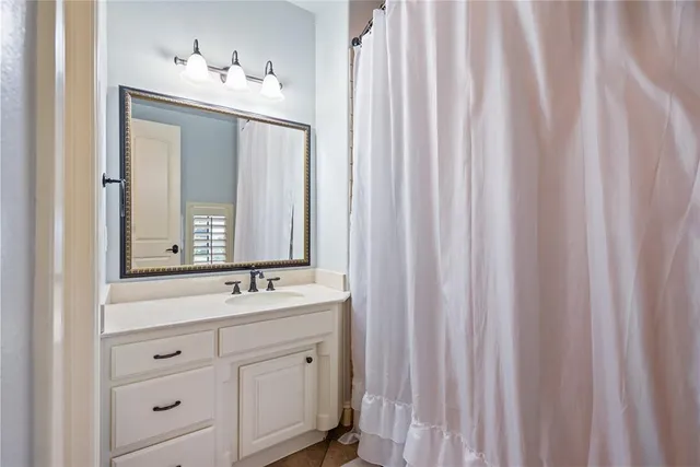a bathroom with a double vanity sink and mirror