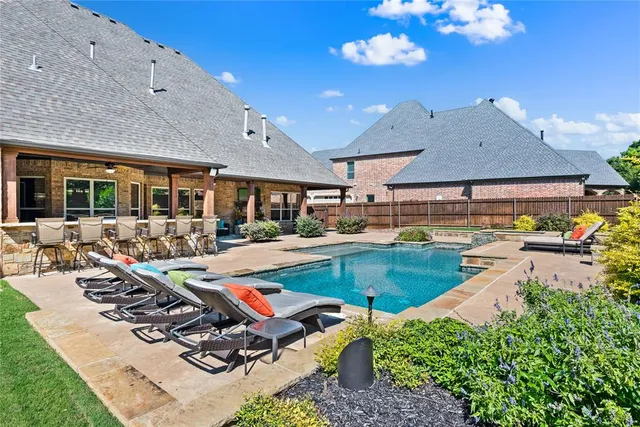 a view of a patio with swimming pool table and chairs
