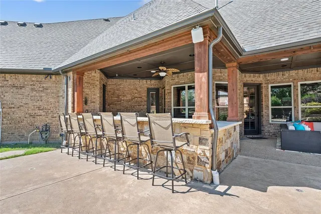 a view of a patio with table and chairs